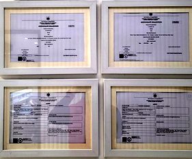 Certificati di registrazione incorniciati alla parete della clinica Creadent, foto reale